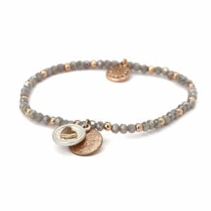 A Grey and Rose Gold - Heart Disc bracelet with a coin charm.