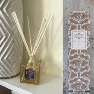A fragrant Reed Diffuser combines the scents of Jasmine and Cedarwood, displayed alongside a vase and a box.