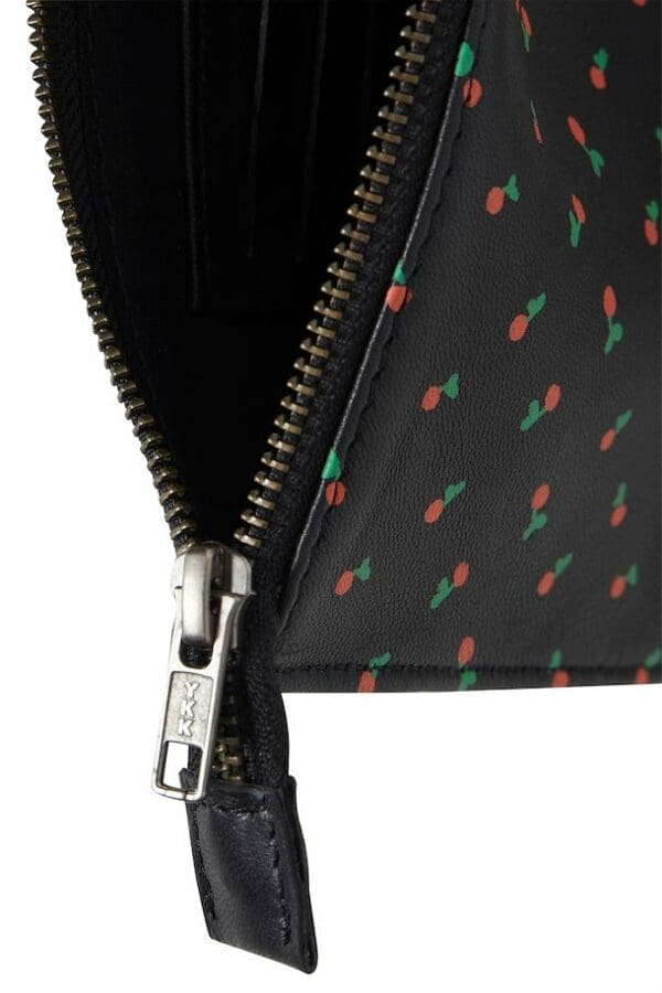 A wallet featuring a leather cherries clutch.