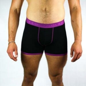 A man donning Men's Bamboo Boxer shorts - Black/Purple.