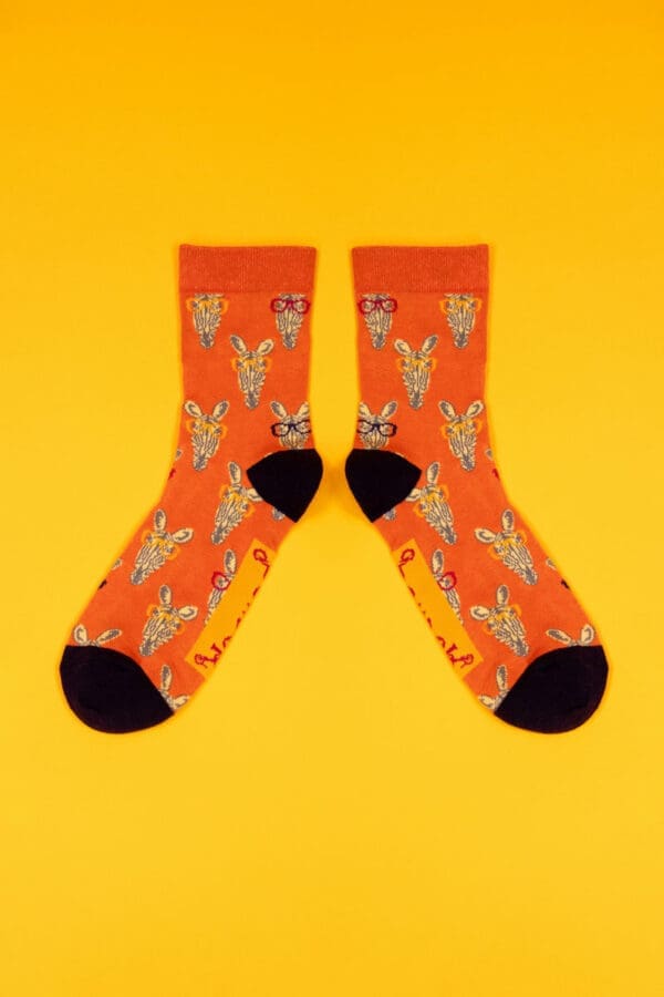 A pair of orange socks with foxes on them. (Import 9903)