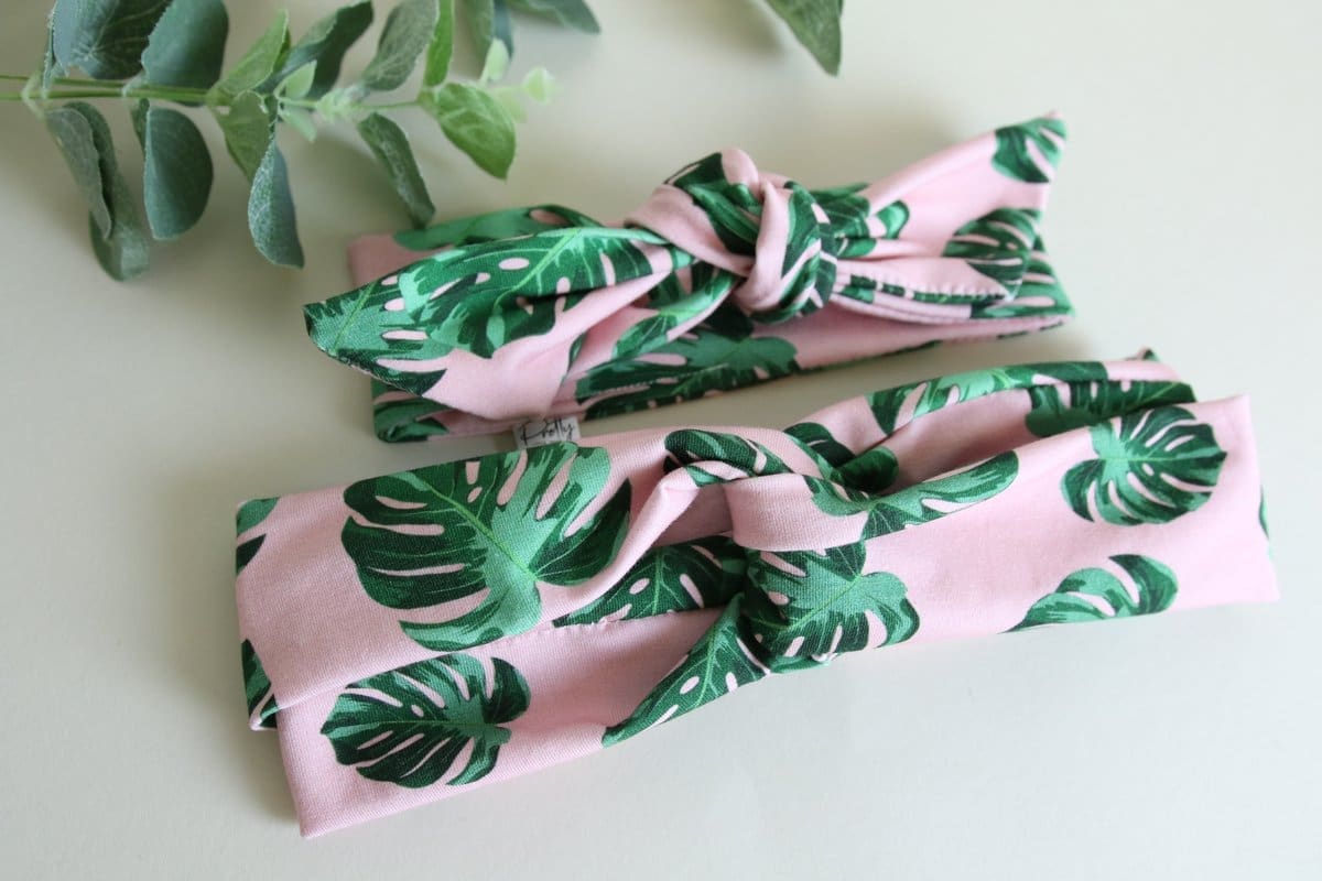 Two pink headbands with import placeholder for 9181 green leaves on them.