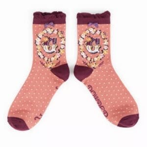 A pair of Import placeholder for 7030 socks with polka dots and a cat on them.