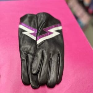 A pair of black leather gloves with a purple lightning bolt on them.