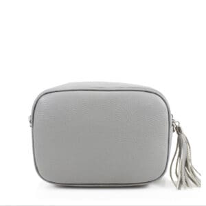 A grey leather cross body bag with a tassel.