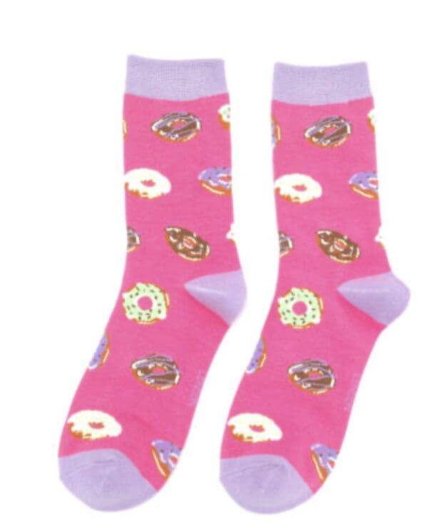 A pair of pink socks with donuts on them.
