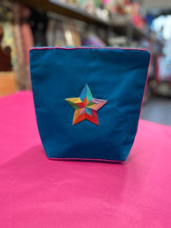 A blue bag with a star embroidered on it.