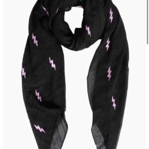 A black scarf with pink lightning bolts on it.