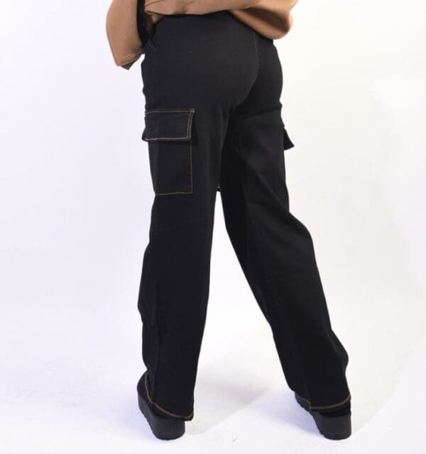 The back view of a woman wearing black cargo pants.