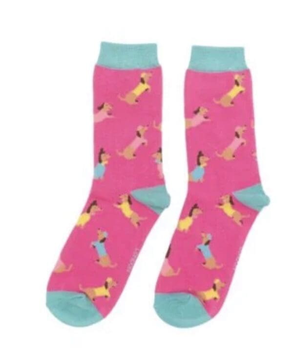 A pair of pink socks with dogs on them.