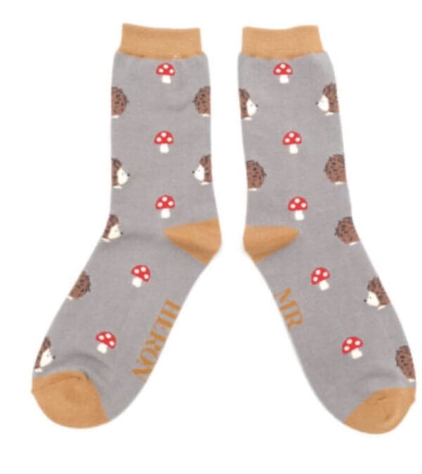 A pair of socks with mushrooms and hedgehogs.