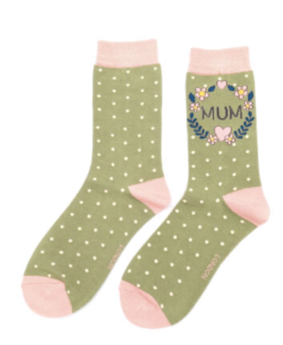 A pair of green socks with polka dots and the word mum.
