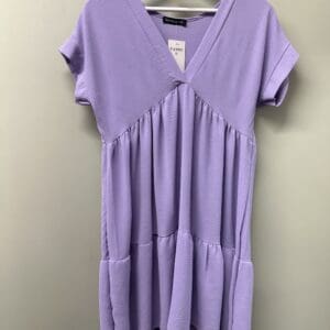 A purple top hanging on a hanger.